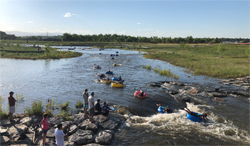 A group of people tubing in the St. Vrain Creek