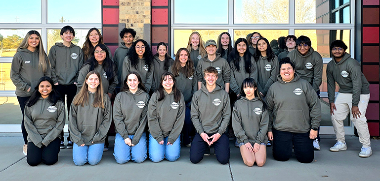 Twenty four people, including 2024 Youth Council and staff members, pose outside of Lashley Station.