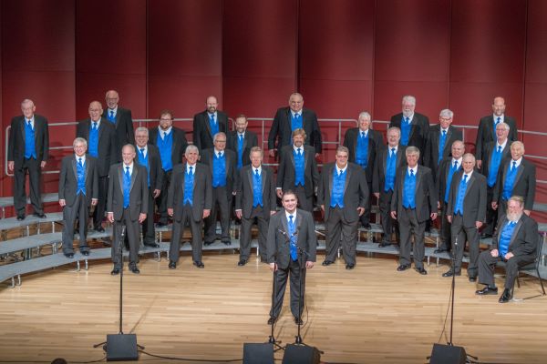 Photograph of Longs Peak Chorus standing on choir bleachers on a stage