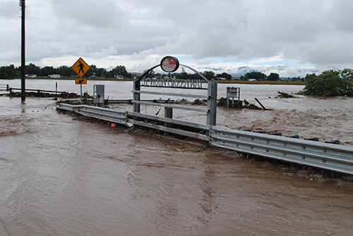 The flooded St. Vrain River in 2013 at a bridge