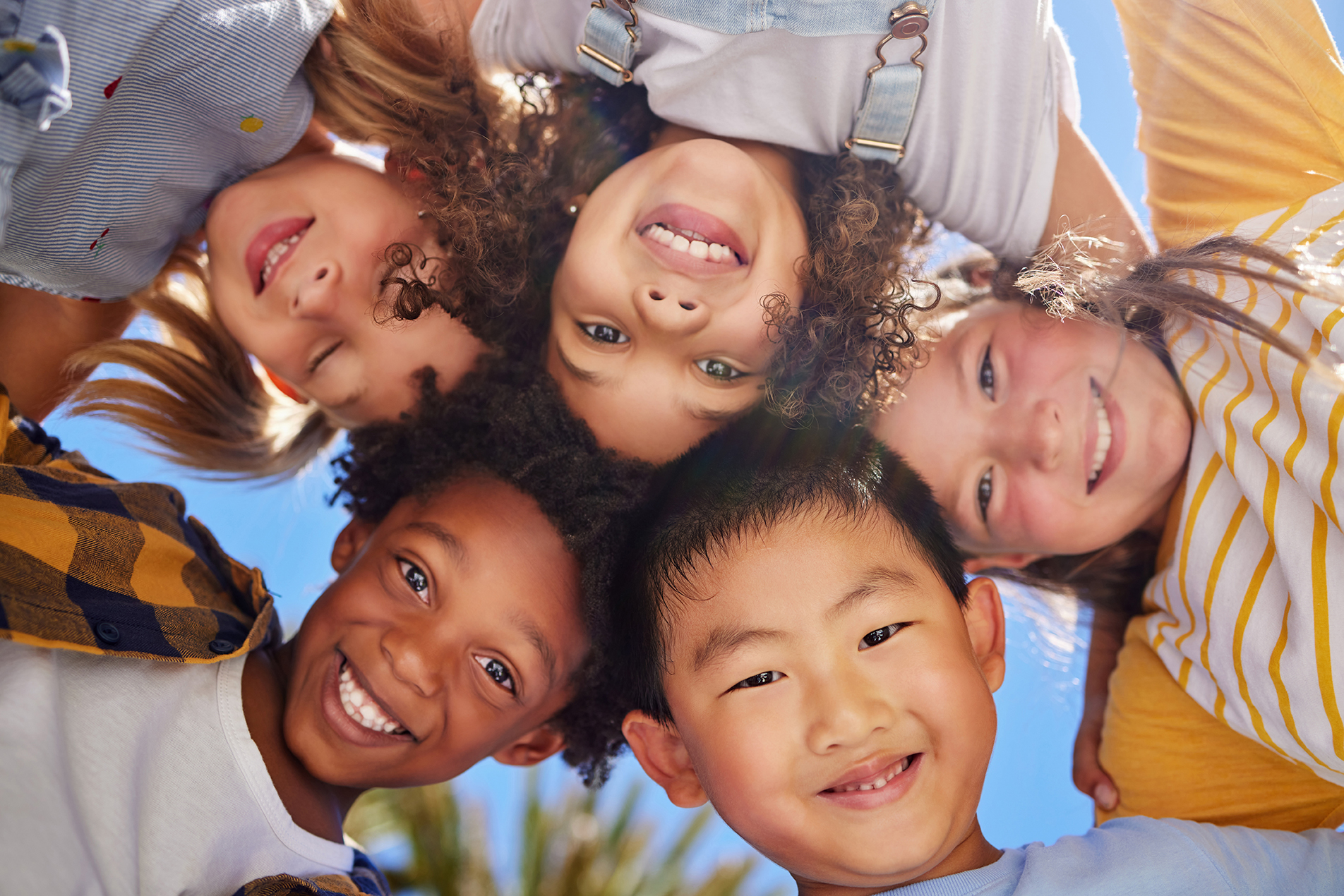 Friends, smile and below portrait of children outdoors for summer holiday, weekend and playing games together. Childhood, friendship and group of kids in circle for diversity, community and support.