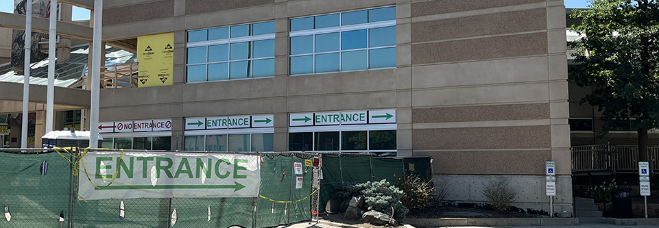 The Longmont Safety and Justice Center is seen while under construction, with several signs indicating the relocated front entrance.