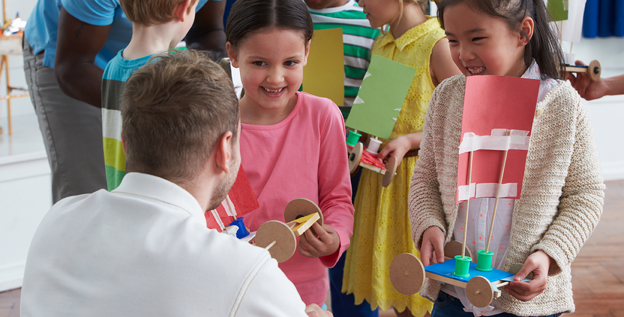 Group Of Children Carrying Out Experiment In Science Class