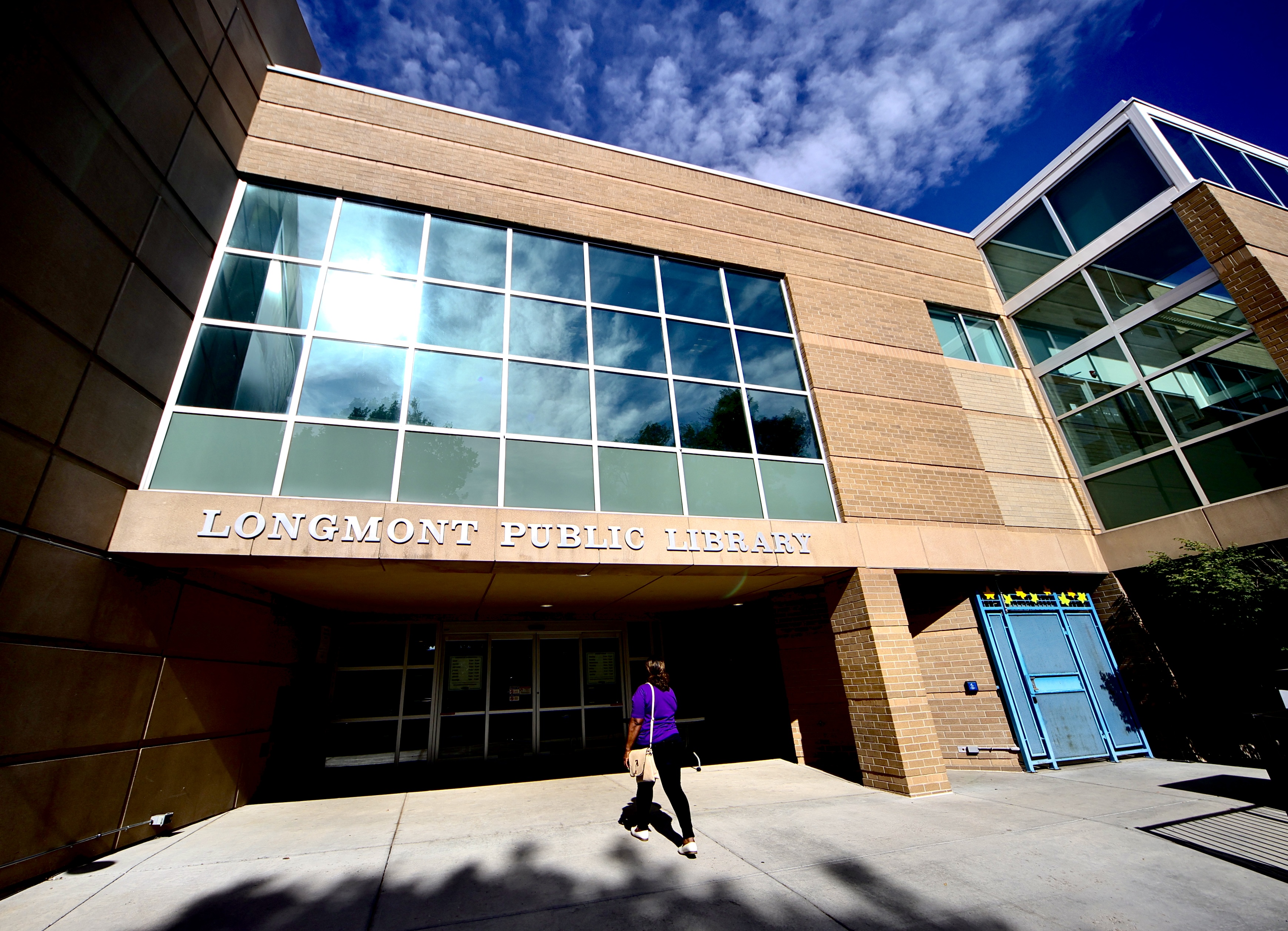 A patron walks into the east entrance of the Longmont Public Library