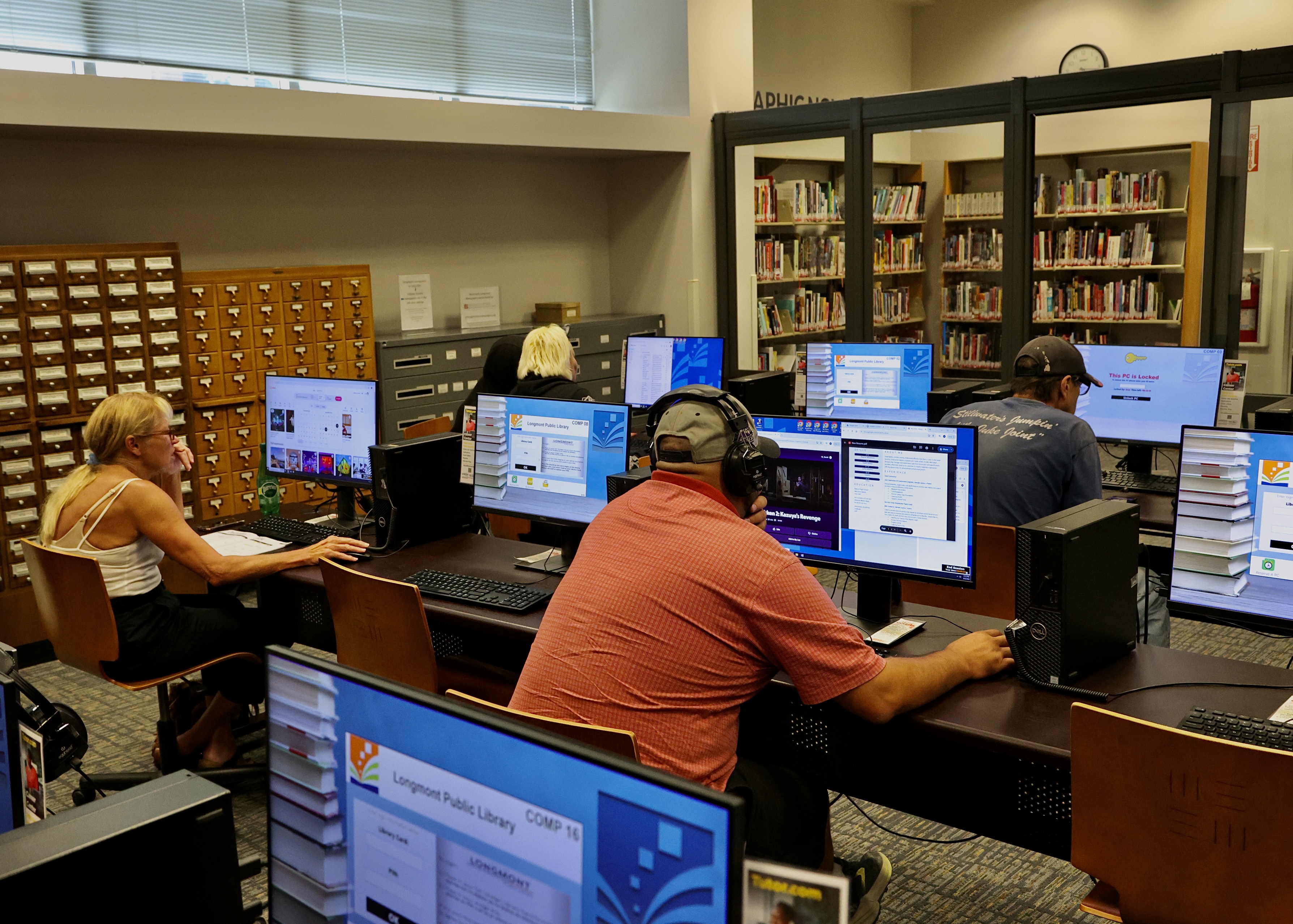 Patrons use desktop computers at the Longmont Library