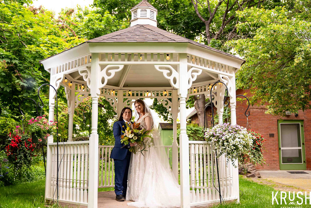 Wedding couple standing the Callahan House Gazebo in an embrace.