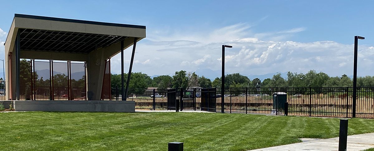 An outdoor courtyard with a grassy field and pavillion