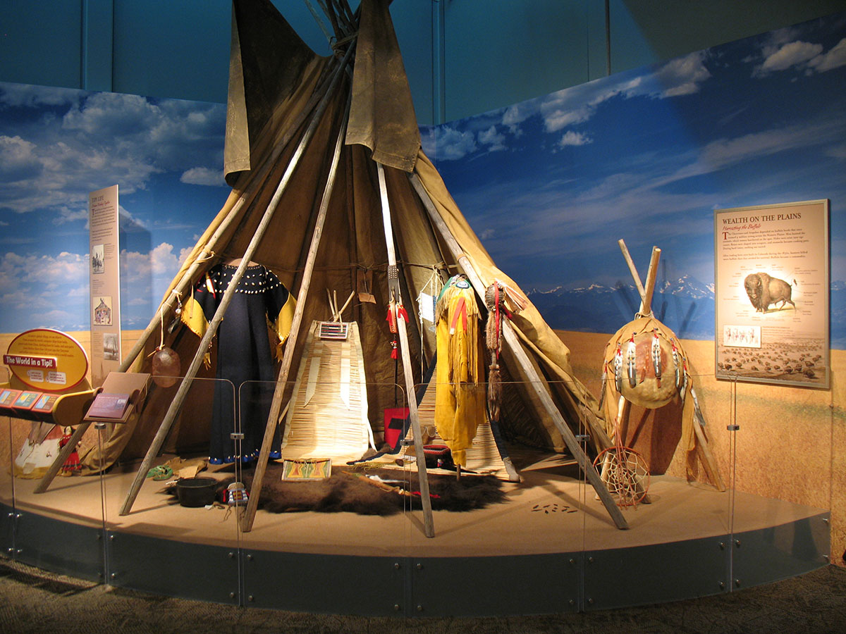 An exhibit on indigenous history with a tipi in the foreground