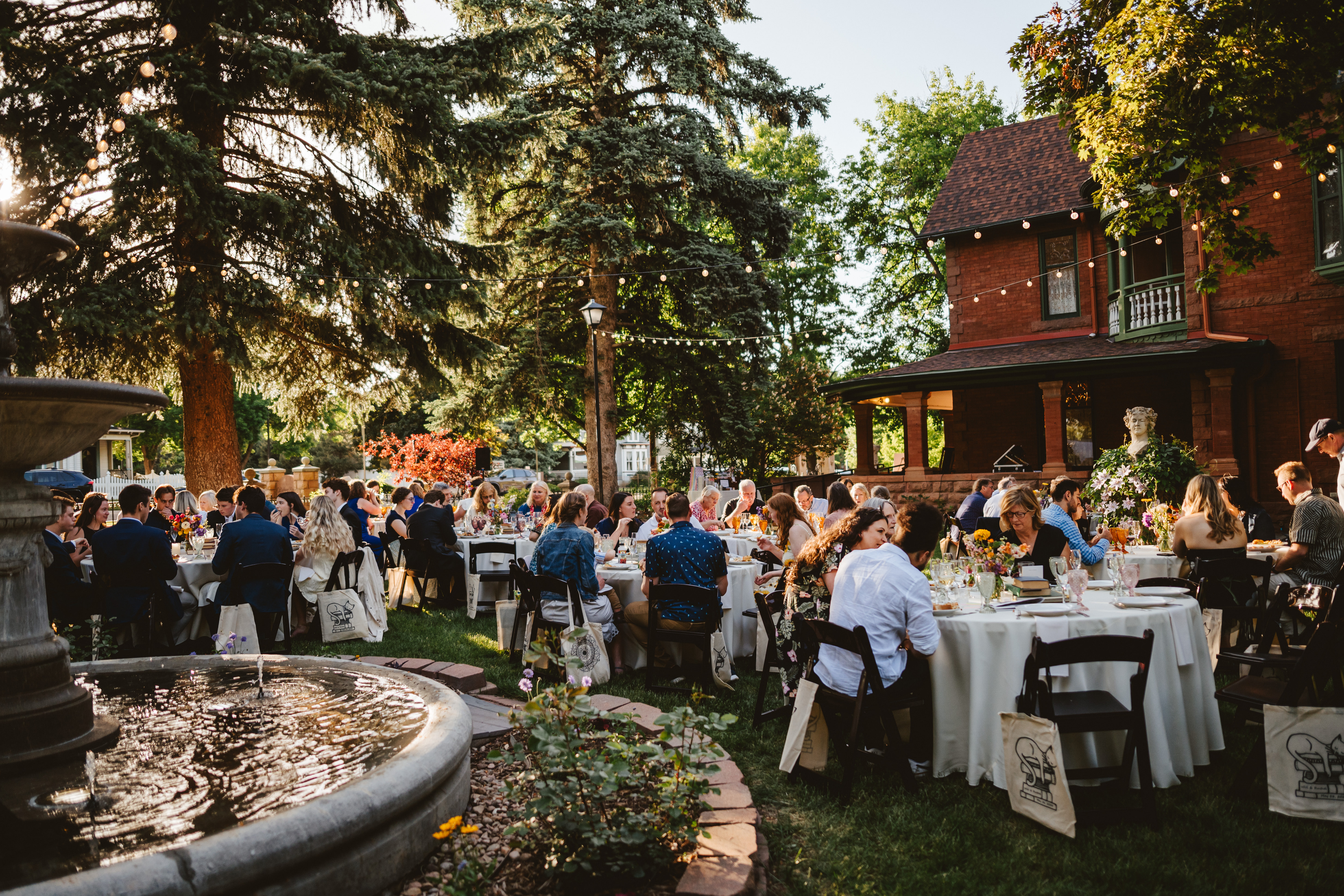 Formal party on the south lawn of the Callahan House. Fountain and House featured in the background.