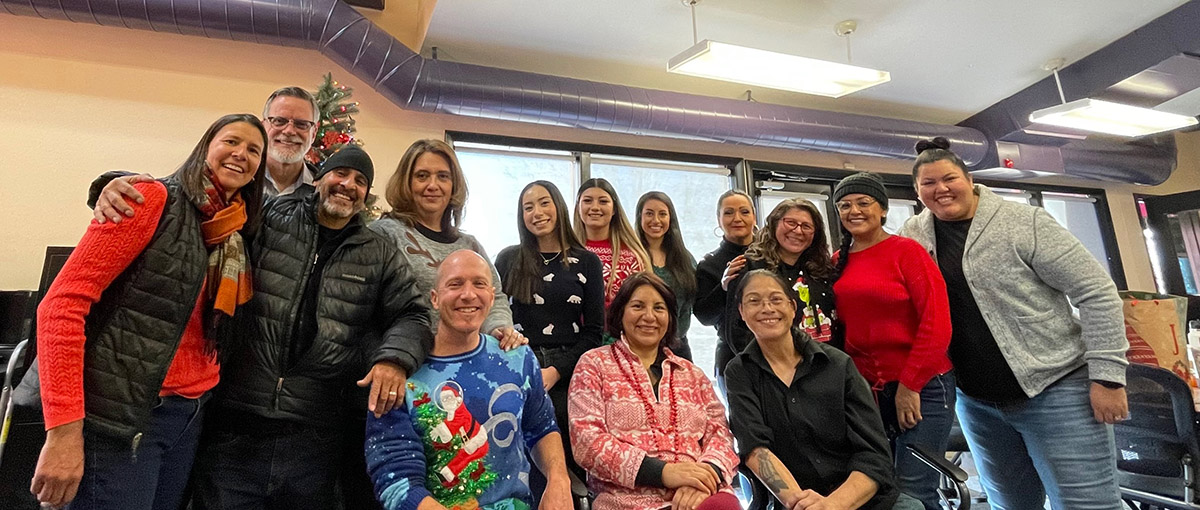 Several people in the Youth Center office celebrate a holiday.