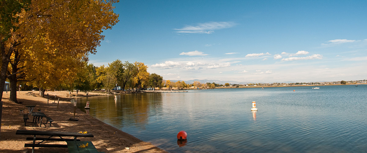 The beach at Longmont's Union Reservoir is seen in autumn. with colorful leaves.